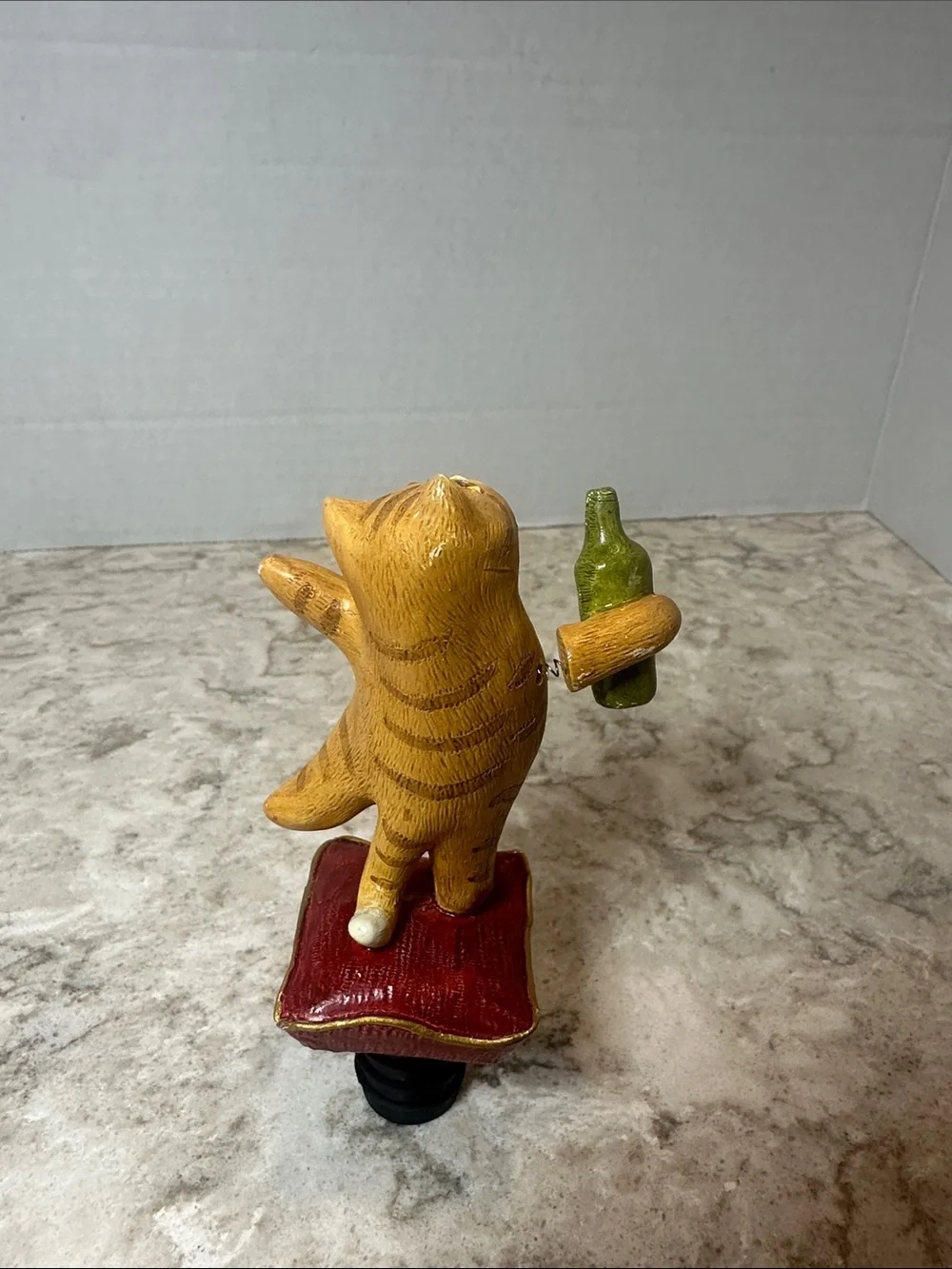 Yellow Cat Figurine Holding Bottle on Red Cushion- Bottle Stopper